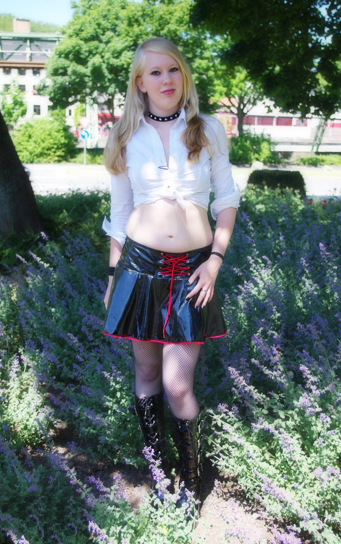 Blonde Gothic Girl wearing Black Fishnet Pantyhose and Black Leather Miniskirt